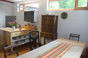 a dining room with a table and a wooden cabinet at Stadtvilla in Murnau am Staffelsee