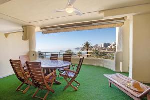 a dining room with a table and chairs on a balcony at Luxury in Puerto Marina in Benalmádena