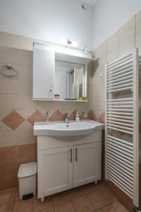 a bathroom with a white sink and a mirror at Nonna in Lefkada +17 photos