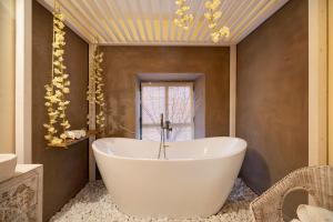 a white tub in a bathroom with a window at Private Spa in Kangen House Jerez in Jerez de la Frontera