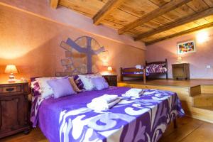 a bedroom with a large bed with a cross on the wall at Rural Pension Istra Partner in Barban