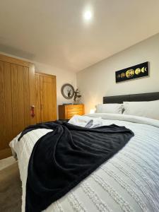 a bedroom with a black blanket on a bed at 1A Priscilla Close in Earlham