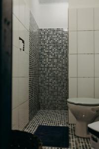 a bathroom with a shower with a toilet and a sink at Pousada Nel Blu in Itaparica +64 photos