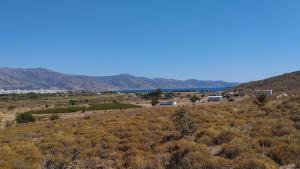 an open field with mountains in the background at Camping.Karystos Melodia in Karistos +5 photos