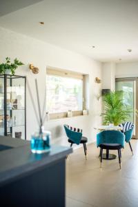 - un salon avec des chaises bleues et une table dans l'établissement Rumi Boutique Hotels&Spa Only adults, à Ascea