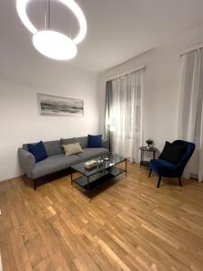 a living room with a couch and a glass table at Charming Apartment close to Vienna Central Station in Vienna