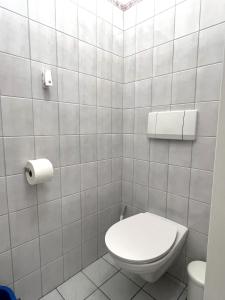 a bathroom with a toilet and a toilet paper dispenser at Charming Apartment close to Vienna Central Station in Vienna