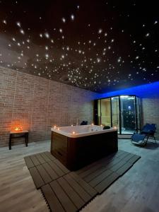 a bath tub in a room with lights on the ceiling at Sunrise Inn & Spa in Pessinetto