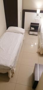 a hospital room with a bed and a desk at Hotel Boccascena in Genoa