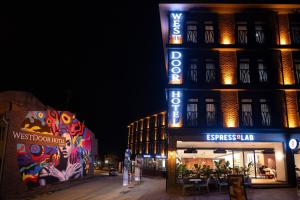 a building with a sign on the side of it at night at WestDoor Hotel in Edirne