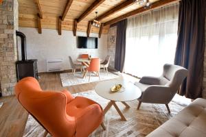 a living room with chairs and a table at Lux Villas Zabljak in Žabljak