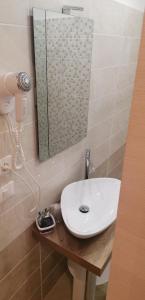 a bathroom with a white sink and a shower at Hotel Boccascena in Genoa