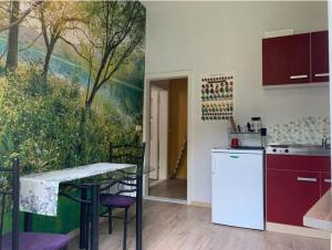 a kitchen with a table and a painting on the wall at Gutshaus Zarnewanz in Zarnewanz