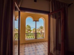 a room with a window with a view of the ocean at Sunny Days Palma De Mirette Resort & Spa in Hurghada