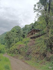 a bridge on the side of a hill with a dirt road at KatuS premium cottages in Gangtok