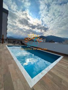 a swimming pool on the roof of a building at Apê212 - 650m da Orla in Ubatuba