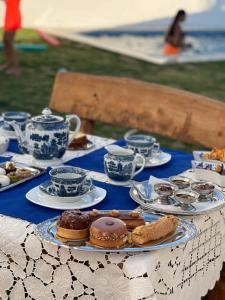 a table with plates of food and cups and biscuits at Dar el benet in Djerba