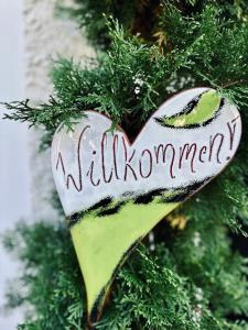a heart ornament hanging on a christmas tree at Ferienhaus sHäuserl in Landl