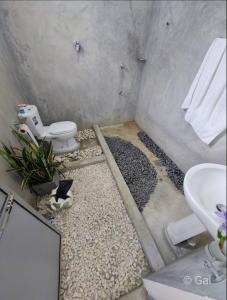 a bathroom with a sink and a toilet and gravel at Lapwing Lake Villa in Tissamaharama +53 photos