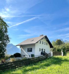 a white house with a metal roof on a field at Ferienhaus sHäuserl in Landl