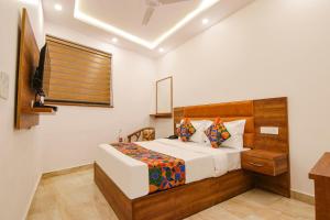 a bedroom with a bed and a television in it at FabHotel Ambassador in Chandīgarh