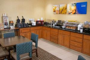 a kitchen with a table and a table and chairs at Comfort Inn Sioux City South in Morningside