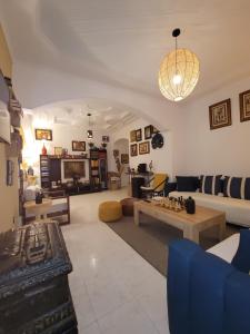 a living room with a couch and a table at Immeuble walili in Fez