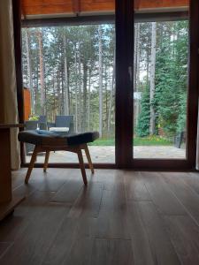 a room with a table in front of a window at Planinska kuća Košuta in Bajina Bašta
