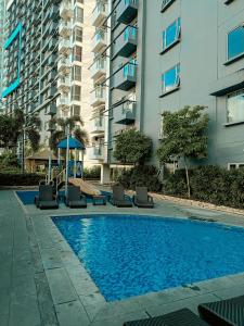 a swimming pool in front of a tall building at The Bat Cave 2 @Manhattan Heights in Manila