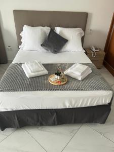 Postel nebo postele na pokoji v ubytování Residencial Santo Amaro