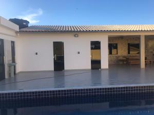 a white building with a pool in front of it at Casa Diamantina in Ibicoara