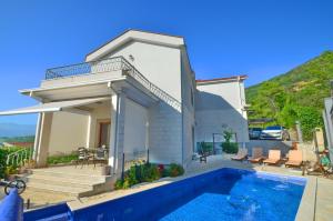 a villa with a swimming pool and a house at Sunny Villa in Kavac in Tivat