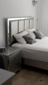 a bed with two pillows on it next to a desk at ForestView Dream Apartment in Bucharest +30 photos