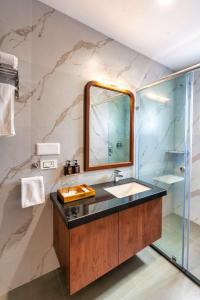 a bathroom with a sink and a mirror at The Grand Fateh in Udaipur