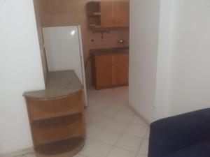 a small kitchen with a counter and a sink at Sheraton ap . in Hurghada