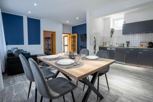 una cucina e una sala da pranzo con tavolo e sedie in legno di MIRA StudioApartments NEU a Castrop-Rauxel Altre 9 foto