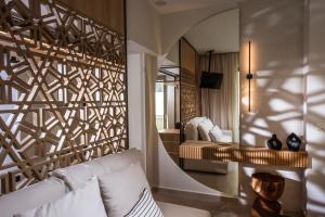 a living room with a white couch and a mirror at Niriides Palace in Gournes