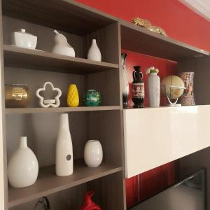 a shelf filled with lots of vases and bowls at jetfastventure in Accra