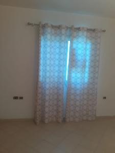 a room with a glass door with a blue light at Sheraton ap . in Hurghada