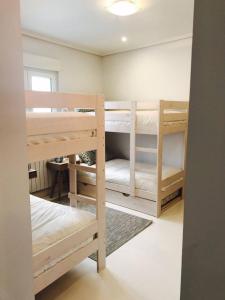 a room with two bunk beds and a table at Txobe Apartment in Elanchove