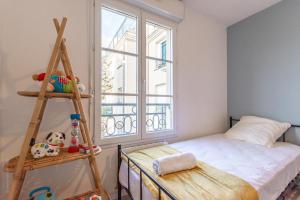 a bedroom with a ladder and a bed and a window at Luxe Flat for 7 - Fairytale Factory in Bussy-Saint-Georges