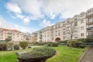 a large apartment building with a park in front at Luxe Flat for 7 - Fairytale Factory in Bussy-Saint-Georges