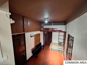 a small kitchen with wooden cabinets and a table at Odyssey's Latara Homestay in Cherrapunji