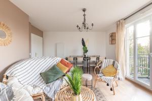 a living room with a bed and a table at Luxe Flat for 7 - Fairytale Factory in Bussy-Saint-Georges