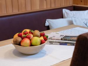 a bowl of fruit sitting on a table at Appartements Spullersee in Lech am Arlberg