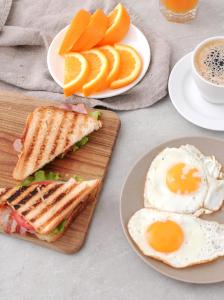 a table with plates of eggs and sandwiches and oranges at Masa Hotel 5 de Outubro in Lisbon +35 photos
