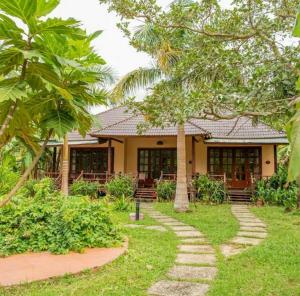 a resort with a pathway leading to a building at Paradiso Phu Quoc Resort in Phu Quoc