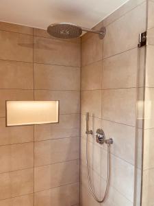 a bathroom with a shower with a shower head at FourElements Grand Chalet in Blankenburg