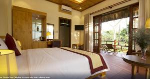 a bedroom with a large bed and a balcony at Paradiso Phu Quoc Resort in Phu Quoc