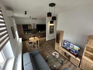 an overhead view of a living room with a couch and a television at Nysa River Apartments Zgorzelec in Zgorzelec